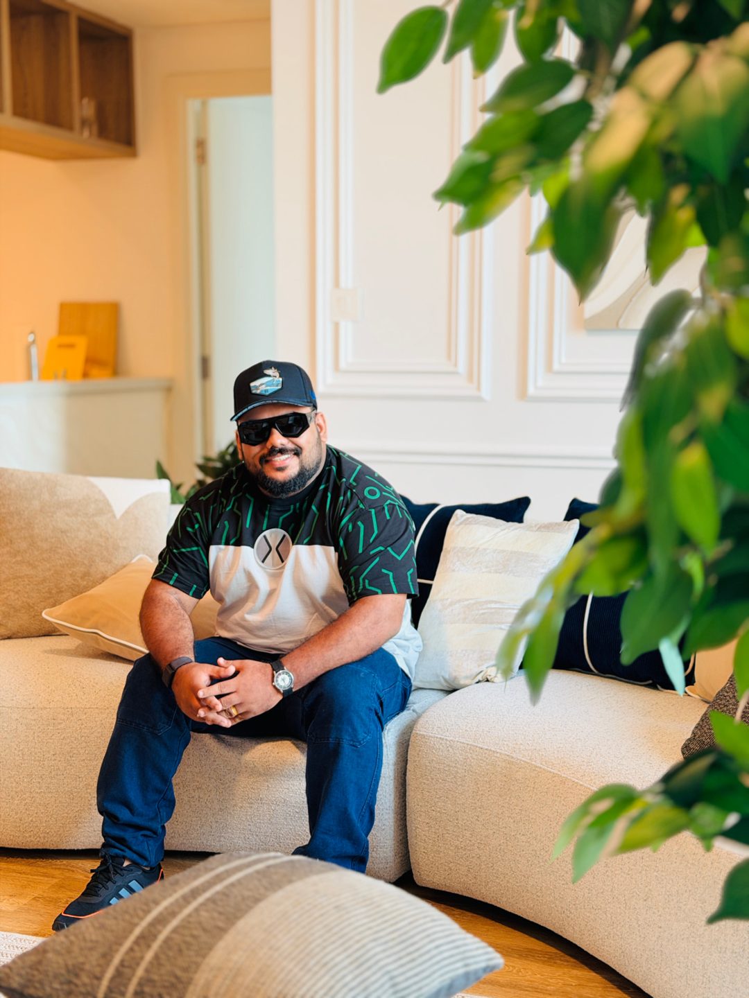 Effin, founder of Neram, seated on a sofa wearing his watch